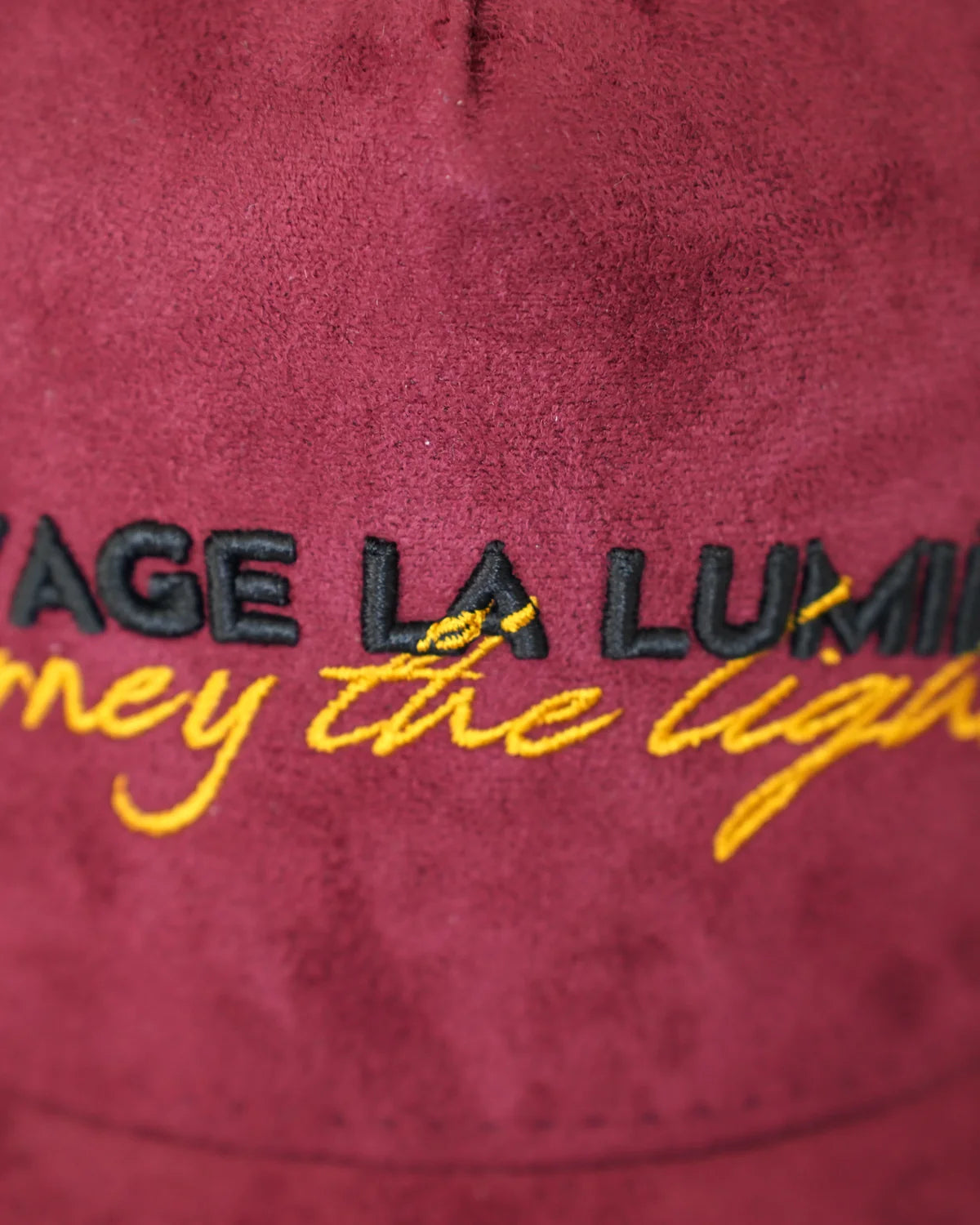 Le Rouge-de-Cuivre, the embroidery close: the house name raised, the script beneath it.