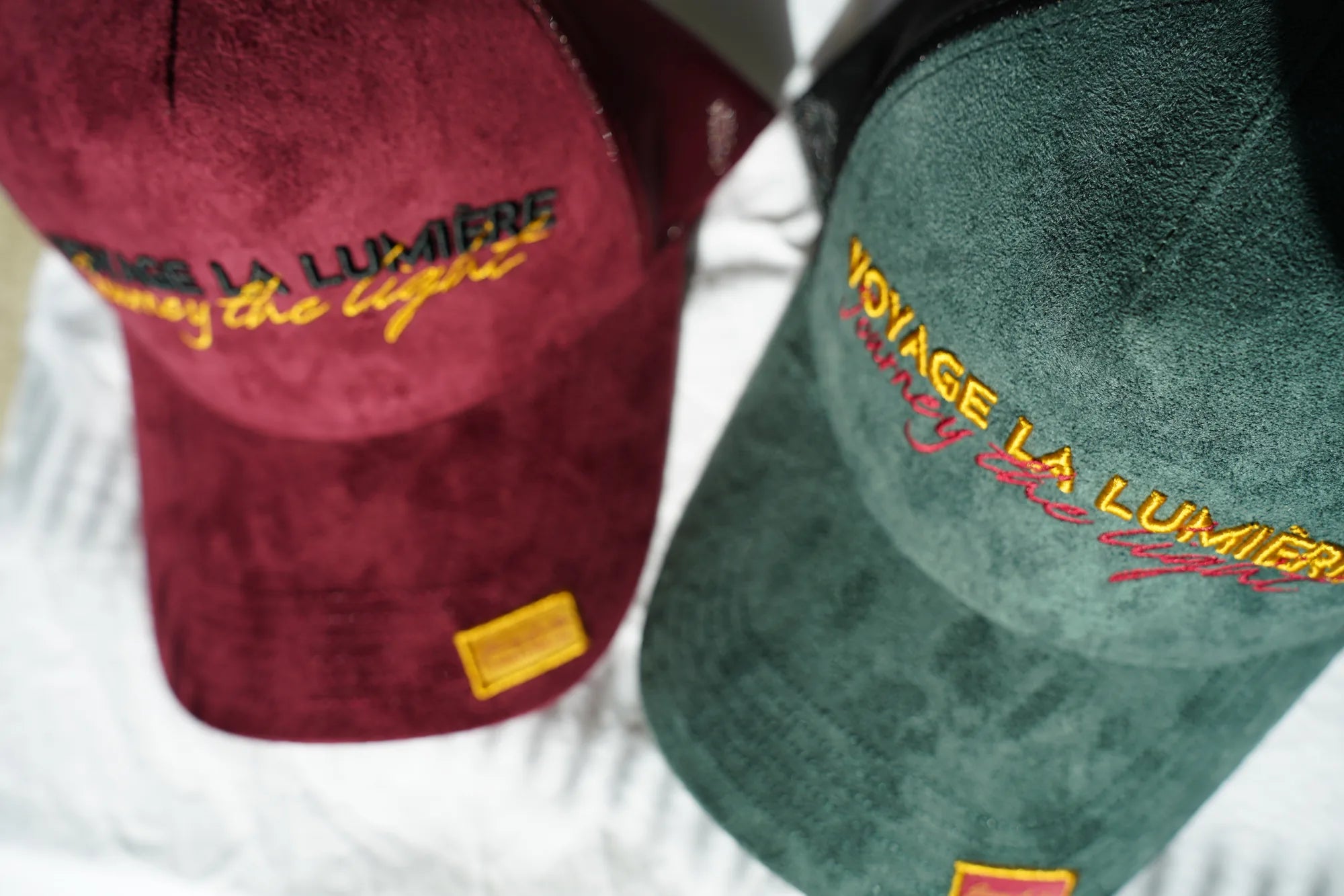 The Suede Trucker Cap in Le Vert-de-Grèce and Le Rouge-de-Cuivre